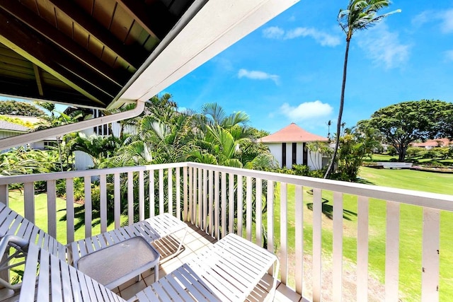 wooden terrace featuring a yard