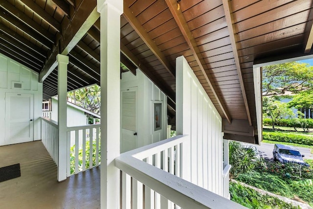 exterior space with wood ceiling, concrete floors, and beamed ceiling