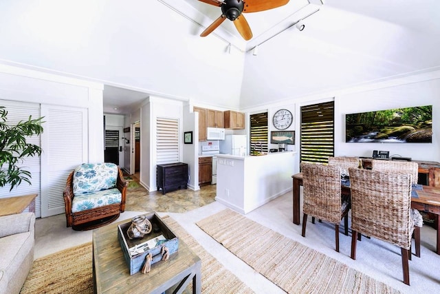 living room featuring ceiling fan, a towering ceiling, and rail lighting