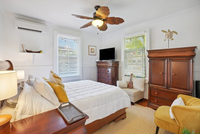 bedroom featuring crown molding, ceiling fan, a wall unit AC, and light hardwood / wood-style flooring