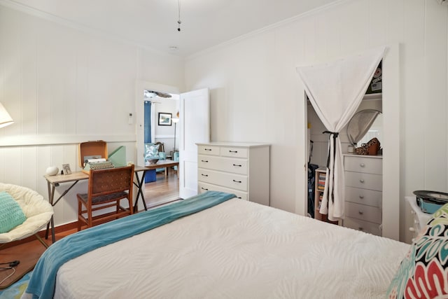 bedroom featuring ornamental molding and hardwood / wood-style flooring