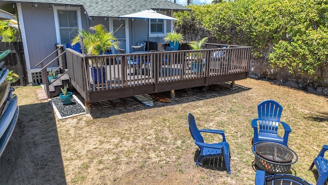 rear view of house with a deck and a lawn