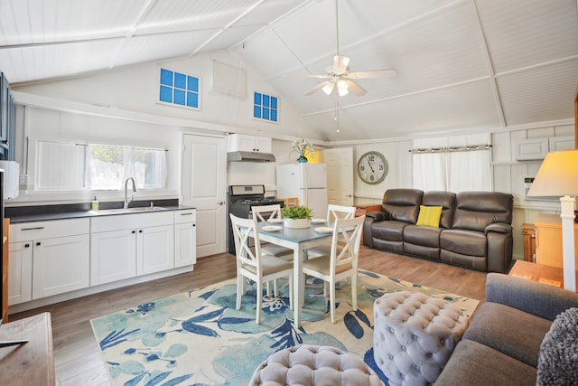 living room featuring lofted ceiling, ceiling fan, sink, and hardwood / wood-style flooring