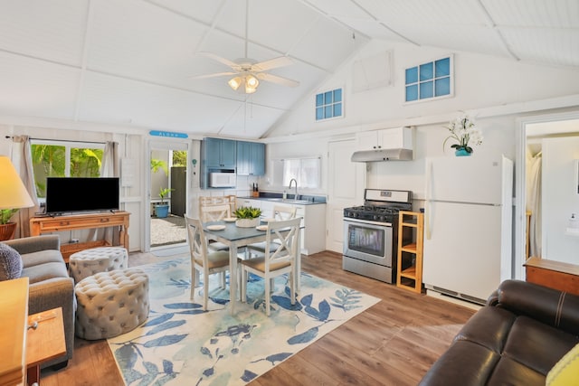 living room with lofted ceiling, light hardwood / wood-style flooring, sink, and ceiling fan