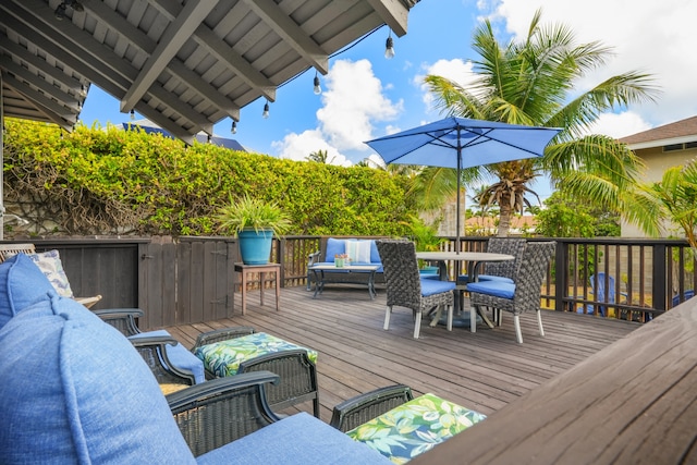 wooden terrace with an outdoor living space