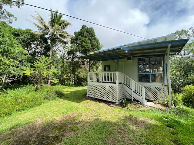 rear view of property with a yard