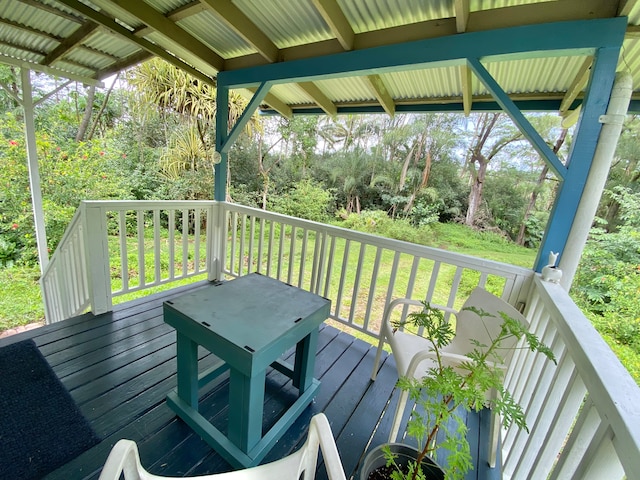 wooden deck featuring a yard