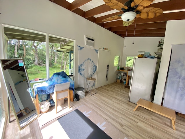 interior space featuring ceiling fan, beamed ceiling, and a wall mounted air conditioner