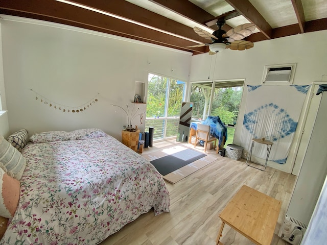 bedroom with light hardwood / wood-style flooring, ceiling fan, an AC wall unit, and beam ceiling