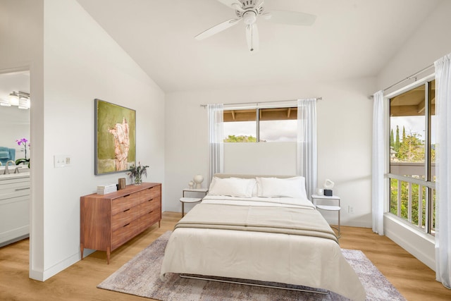 bedroom featuring ceiling fan, light hardwood / wood-style floors, vaulted ceiling, and multiple windows