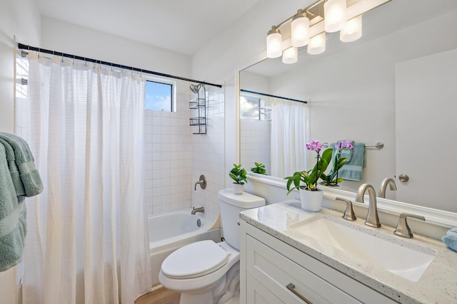 full bathroom featuring vanity, shower / bathtub combination with curtain, and toilet