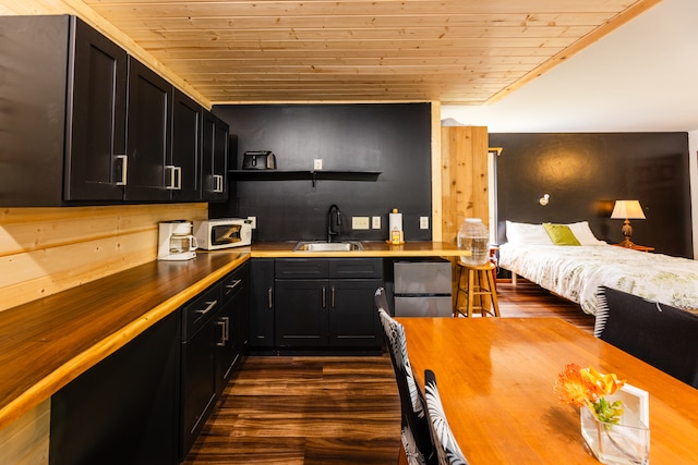 bar featuring dark hardwood / wood-style flooring, sink, butcher block counters, and wood ceiling