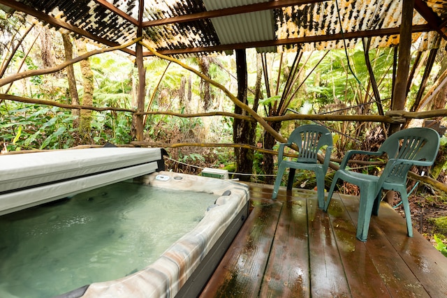 wooden terrace with a covered hot tub