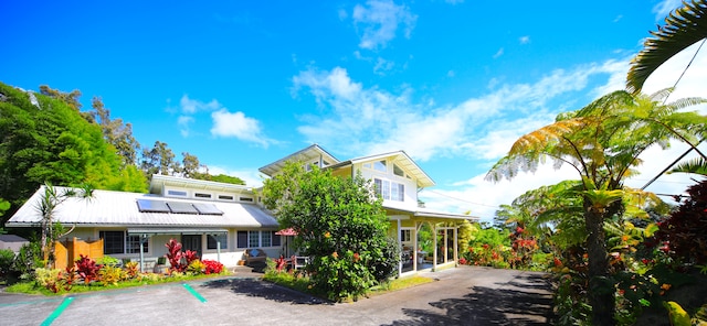 view of front of home featuring solar panels