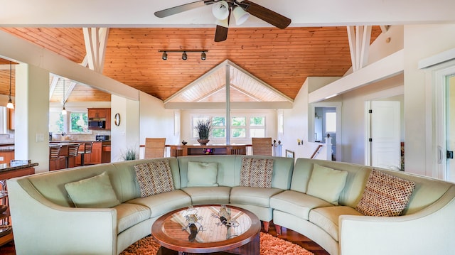 living room featuring ceiling fan, vaulted ceiling, and wooden ceiling