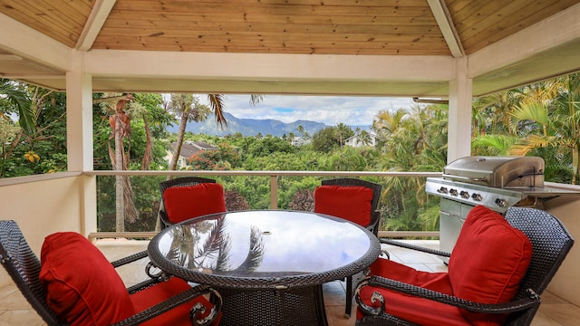 exterior space with a grill, a mountain view, and a gazebo