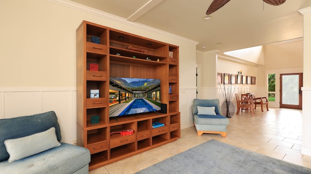 sitting room with ceiling fan, light tile patterned floors, and ornamental molding