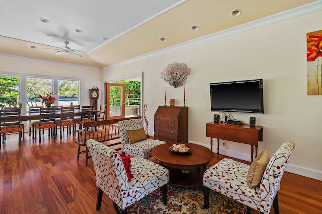 living room featuring crown molding, dark wood-type flooring, and ceiling fan