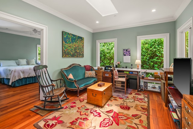 interior space featuring hardwood / wood-style floors, ceiling fan, and ornamental molding