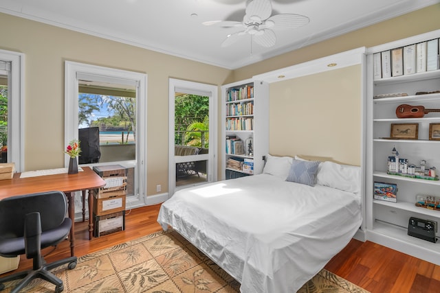 bedroom with light wood-type flooring, ornamental molding, access to outside, and ceiling fan