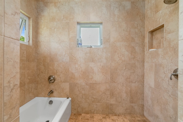 bathroom featuring a wealth of natural light and plus walk in shower