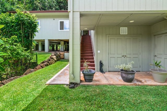 view of exterior entry with a yard