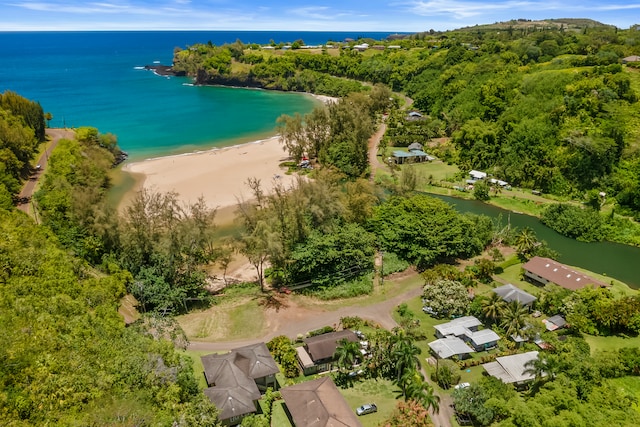 birds eye view of property featuring a water view and a beach view