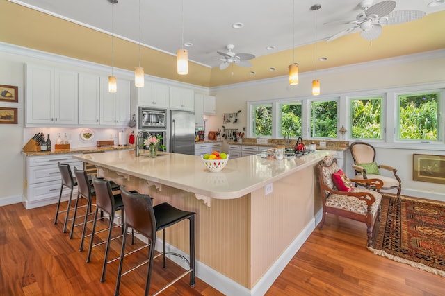 kitchen with light hardwood / wood-style floors, ceiling fan, an island with sink, and white cabinetry