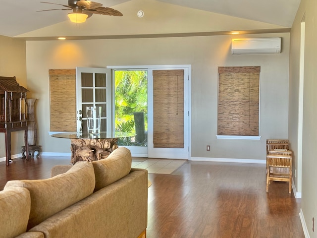 living room with hardwood / wood-style floors, lofted ceiling, and a wall unit AC