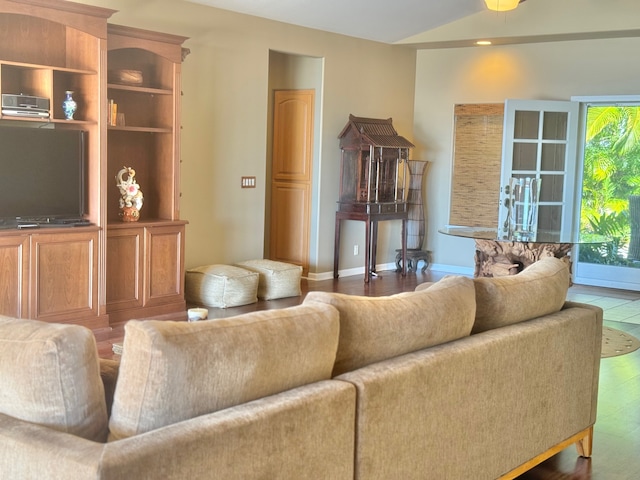 living room with dark hardwood / wood-style floors and a healthy amount of sunlight