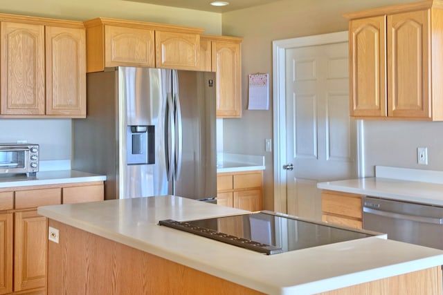 kitchen featuring light brown cabinets, a center island, and appliances with stainless steel finishes