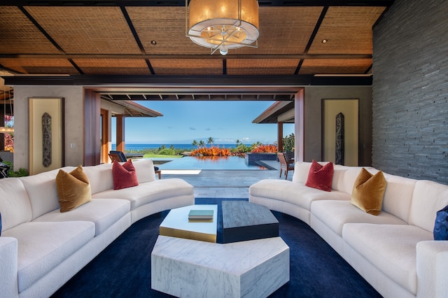 living room with a water view, hardwood / wood-style floors, a chandelier, and wooden ceiling