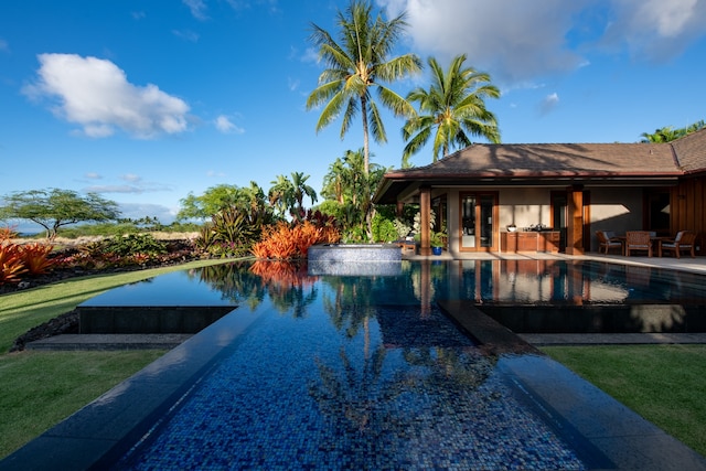 view of pool featuring a yard and a patio