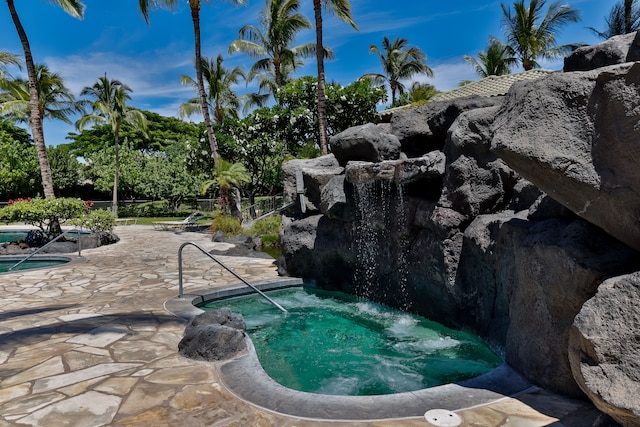 view of swimming pool featuring an in ground hot tub and a patio area