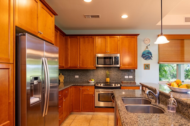 kitchen with stone counters, sink, stainless steel appliances, backsplash, and light tile patterned floors