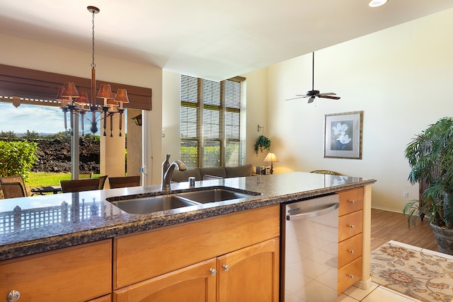 kitchen with dishwasher, sink, light hardwood / wood-style flooring, decorative light fixtures, and ceiling fan with notable chandelier