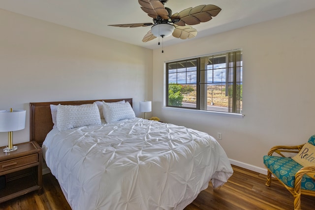 bedroom with ceiling fan and dark hardwood / wood-style flooring