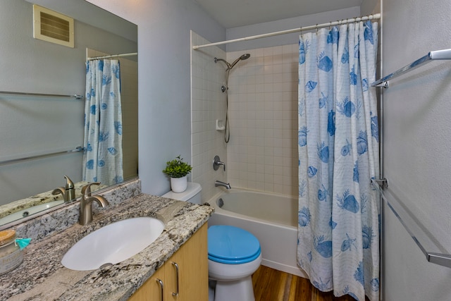 full bathroom with toilet, hardwood / wood-style flooring, shower / tub combo with curtain, and vanity