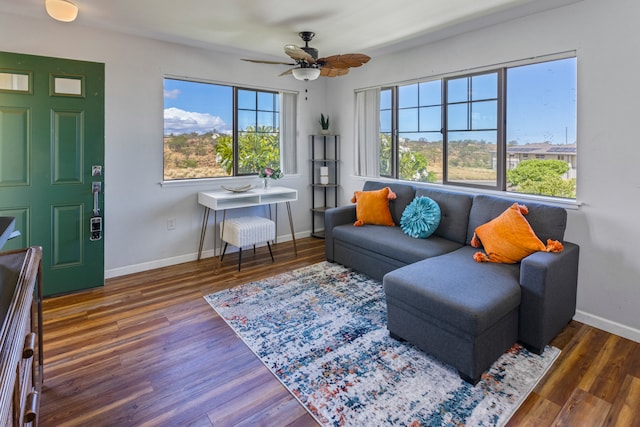 living room with ceiling fan and dark hardwood / wood-style floors