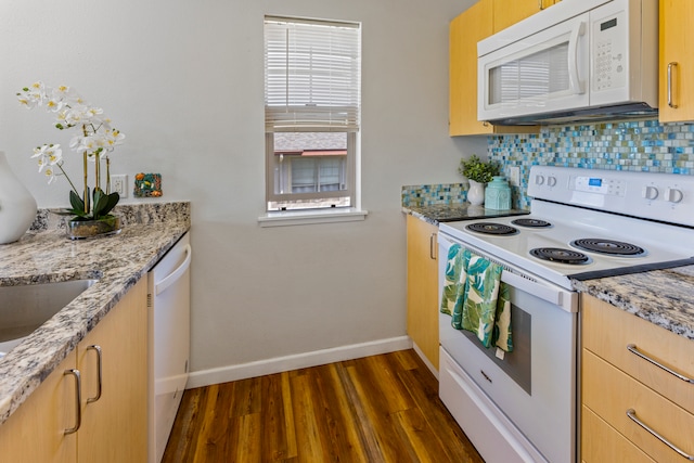 kitchen featuring dark hardwood / wood-style floors, light stone countertops, white appliances, light brown cabinetry, and decorative backsplash