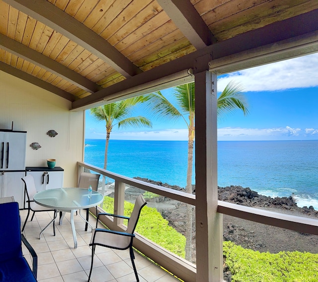 sunroom / solarium with lofted ceiling with beams, a water view, and wooden ceiling