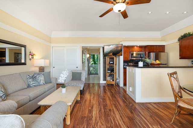 living room featuring dark hardwood / wood-style flooring and ceiling fan