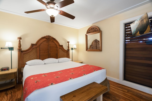 bedroom featuring ceiling fan, dark hardwood / wood-style floors, and crown molding