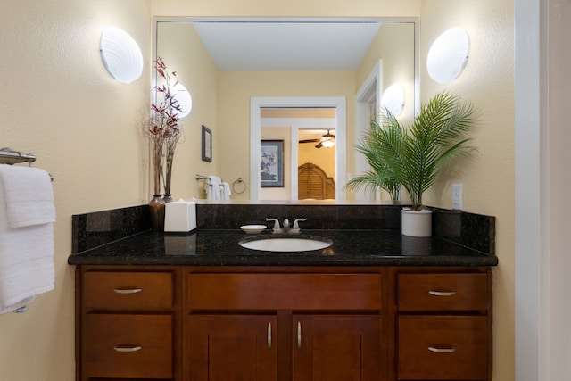 bathroom with ceiling fan and vanity