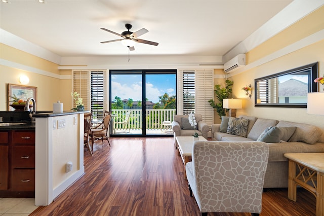 living room with dark hardwood / wood-style flooring, a wall unit AC, sink, and ceiling fan