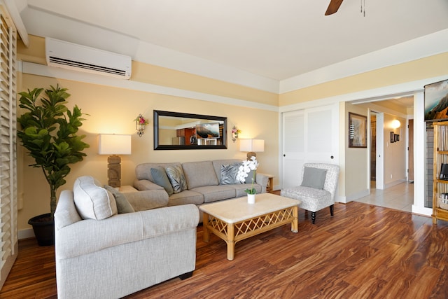 living room featuring hardwood / wood-style flooring, a wall unit AC, and ceiling fan