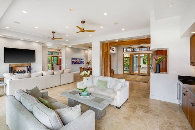 living room featuring ceiling fan and plenty of natural light