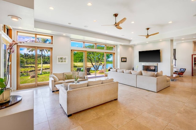 living room featuring ceiling fan and light tile patterned flooring