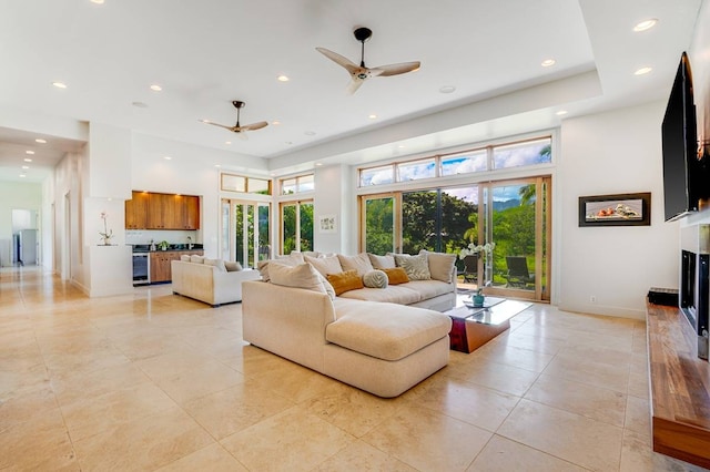 living room with ceiling fan and light tile patterned floors