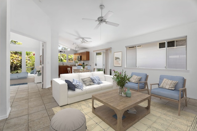 living room featuring ceiling fan, sink, light tile patterned floors, and vaulted ceiling